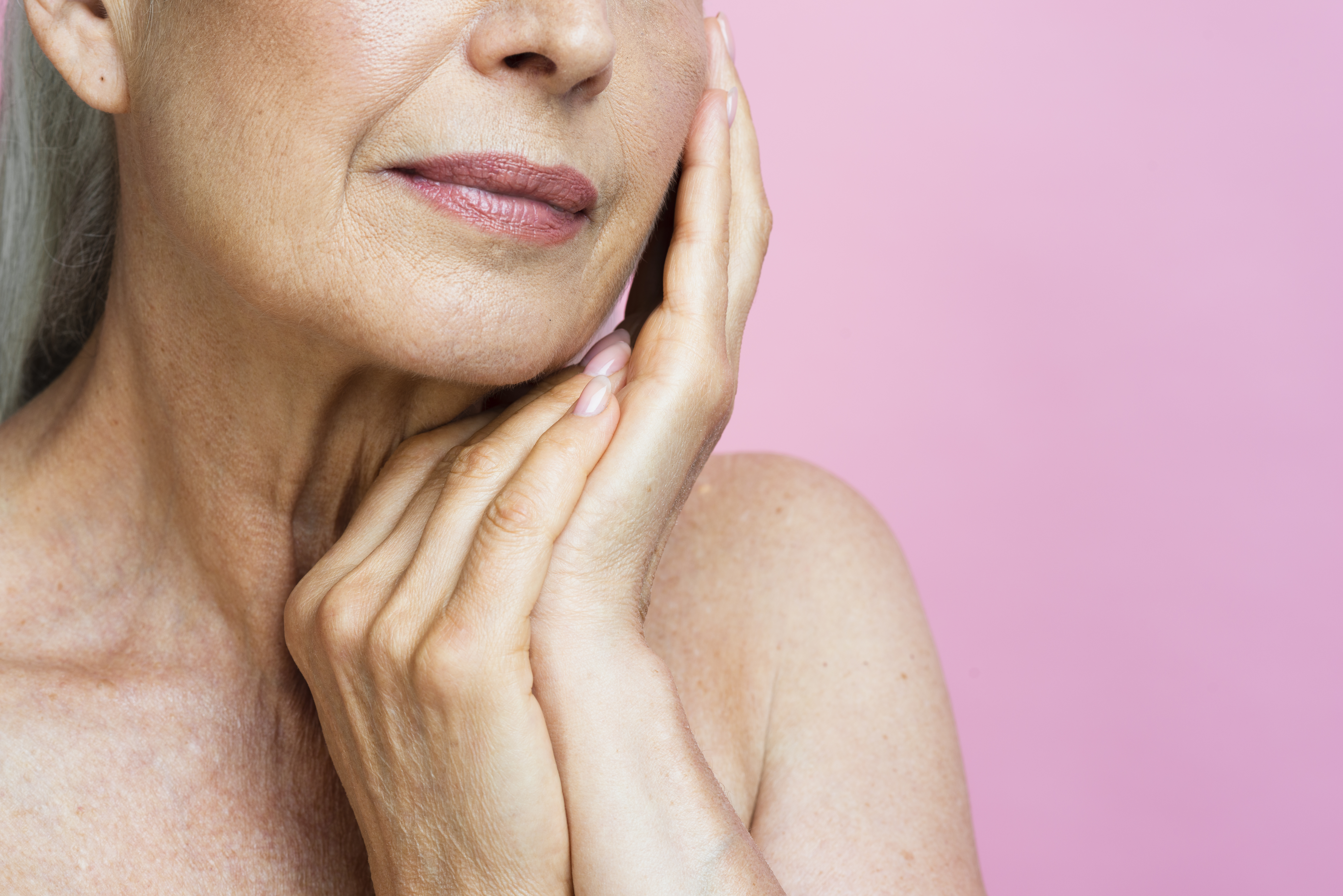 close-up-senior-woman-with-pink-background (1)
